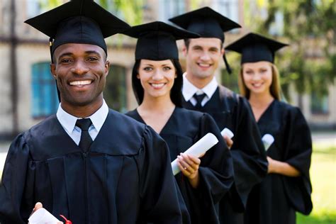 Happy College Graduates Four College Graduates Standing In A Row And