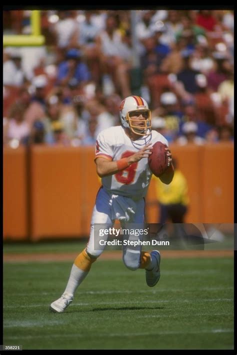 Quarterback Steve Young of the Tampa Bay Buccaneers looks to pass the ...