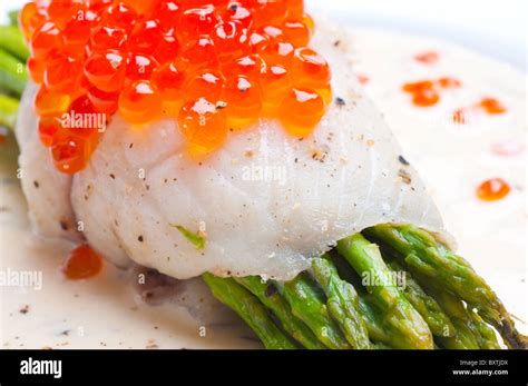 Asparagus With Fish And Red Caviar In Creamy Sauce Stock Photo Alamy