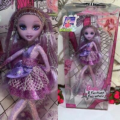 The Doll Is In Its Box And It S Pink With Purple Glitters On It