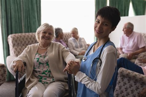 Premium Photo Female Doctor Holding Hands Of Disabled Senior Woman In