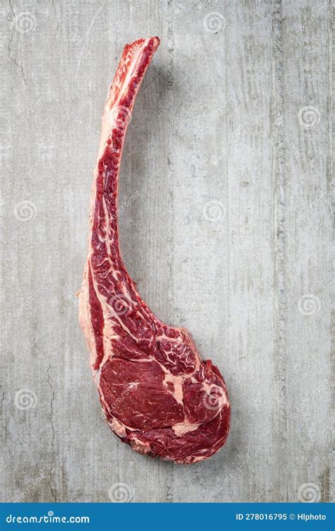 Raw Wagyu Tomahawk Beef Steak With Salt And Pepper On A Grey Design