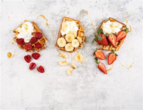 Traditional Belgian Waffles With Fresh Fruit And Cream On A White