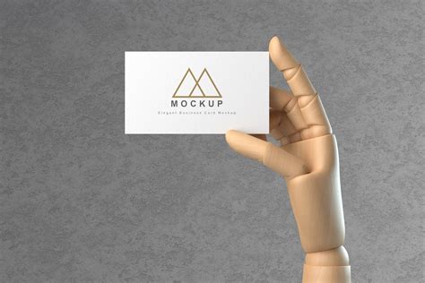 Wooden Hand Holding Business Card Mockup By GraphicList TheHungryJPEG