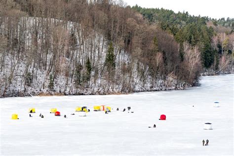 Fishermen Fishing on a Frozen Lake in Winter Stock Photo - Image of coast, lake: 268349300