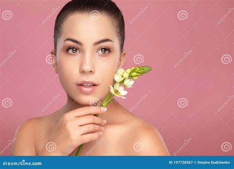 Portrait Of A Beautiful Smiling Brunette Woman With Naked Shoulders