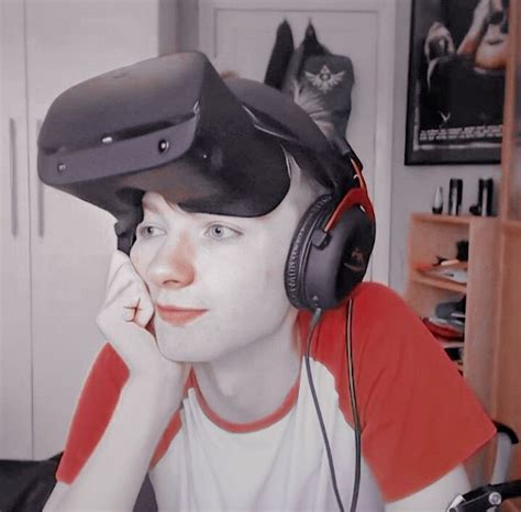 A Woman With Headphones On Sitting In Front Of A Computer Monitor