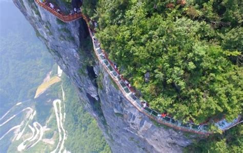 Coiling glass skywalk opened in China lets people walk on a sheer cliff ...