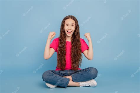 Premium Photo Portrait Of Astonished Small Girl Sit Floor Raise Fists