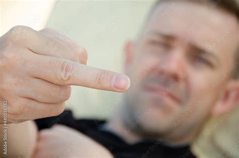 Close Up Fuck You Sign Against The Background Of Rude Man S Face