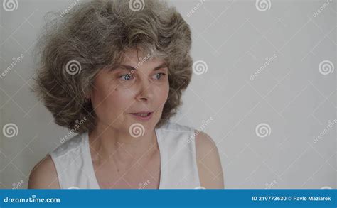 Portrait Of Mature Nude Woman Talking At Camera On Background Stock