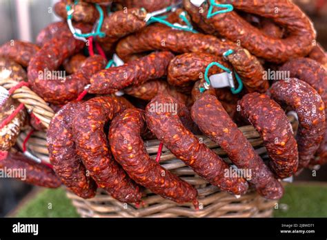 Stacks Of Dry Cured Sausages Saucisson Typically Made Of Pork Or A