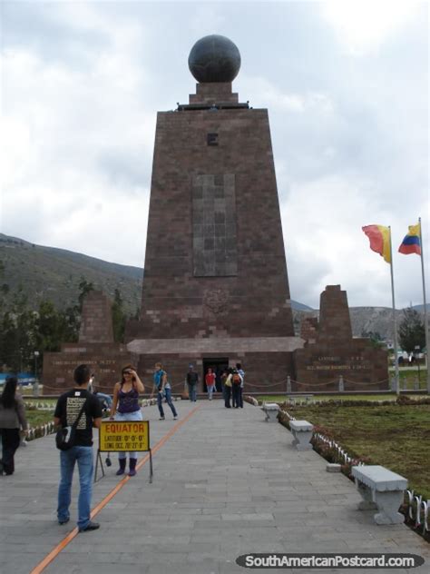 People Taking Photos Standing On The Equator Line At Mitad Del Mundo