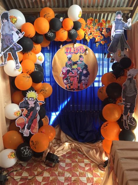 An Orange And Black Balloon Arch Decorated With Cartoon Characters