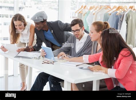 Fashion Designers Discussing Designs In Studio Stock Photo Alamy