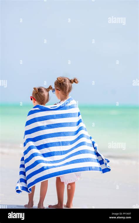 Adorable Little Girls Wrapped In Towel At Tropical Beach After Swimming