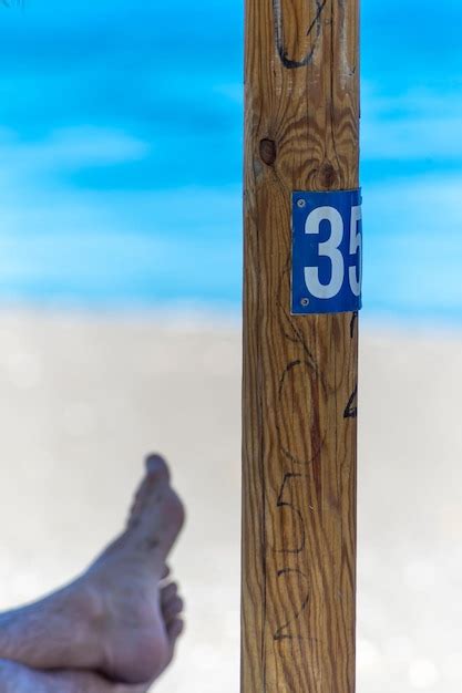premium photo wooden sign   beach number  feet   background