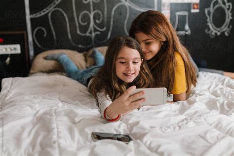 Girls Taking Selfie Phones And Smiling By Stocksy Contributor Dejan