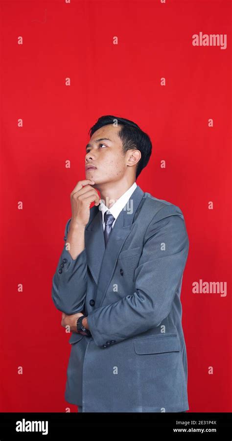 Business Asian Man Thinking And Get Some Ideas Isolated Red Background