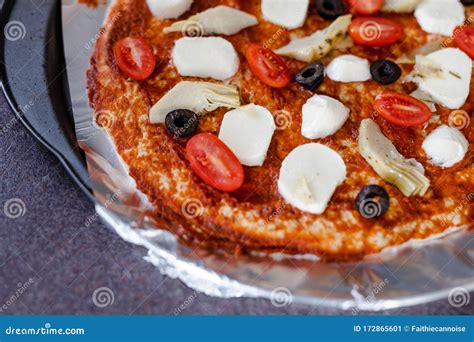 Homemade Vegetables Pizza With Olives And Cherry Tomatoes Topping Being