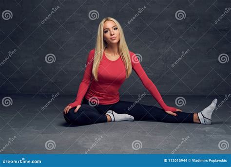 Blonde Girl Sits On A Floor In A Studio Over Grey Background Stock Photo Image Of Active