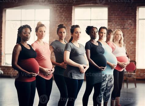 A group of expectant mothers proudly showcase their baby bumps while