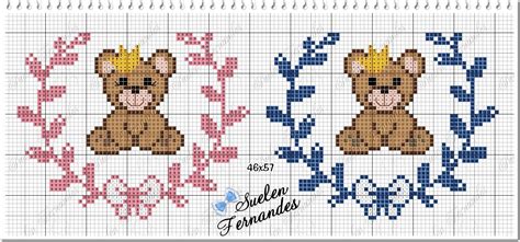 Two Cross Stitch Teddy Bears Sitting Next To Each Other On A White