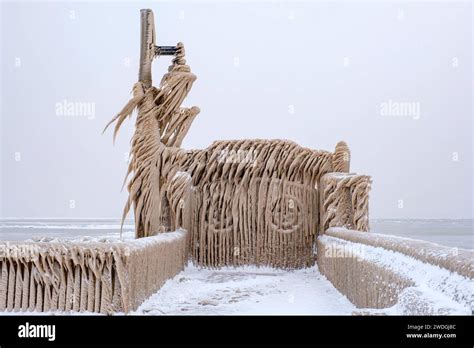 Winter wonderland, gates of Port Stanley pier covered by icicles from Lake Erie frozen waves ...