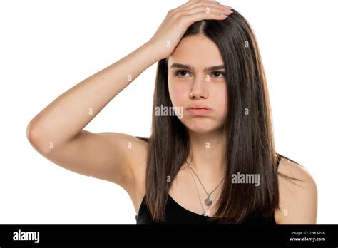 Young Frustrated Girl Holding Her Head With Her Hand On A White