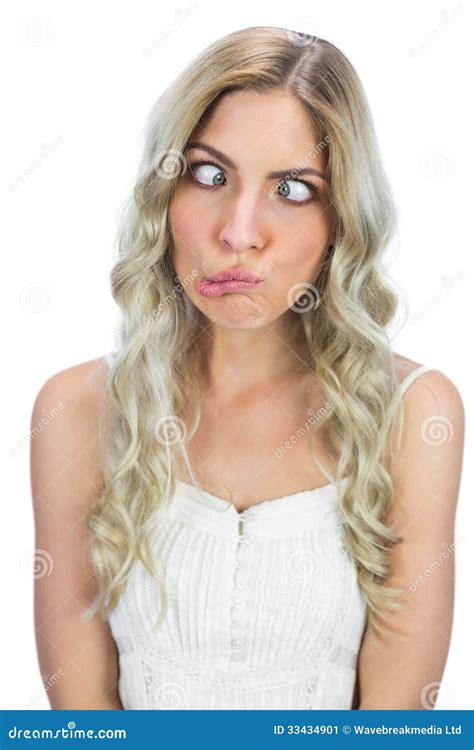 Funny Blonde Girl In Glasses Writhing Her Face Mimicking Having Fun Close Up Royalty Free