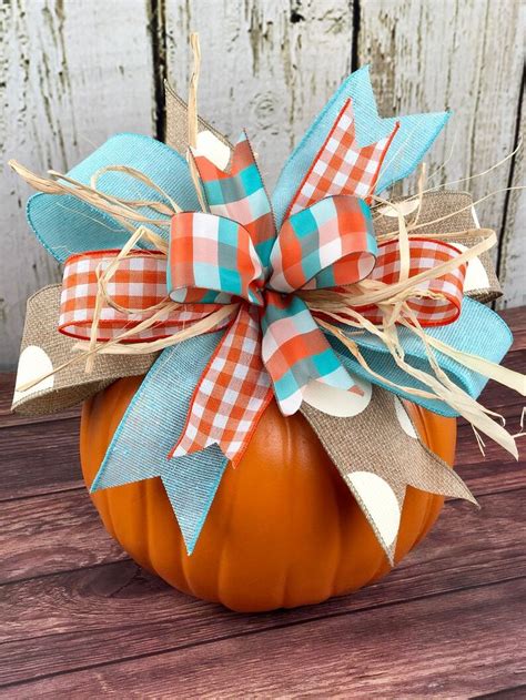 An Orange Pumpkin With A Bow On It