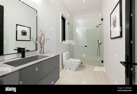 A Spacious Bathroom Featuring A Dual Sink Vanity Modern Shower And