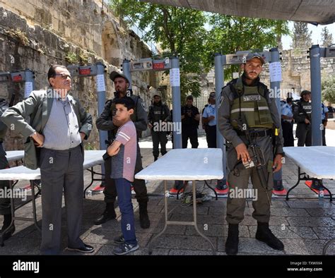 An Israeli Border Police Waits To Screen Palestinian Muslims At A Newly