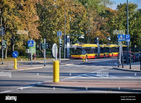 Modern trolley bus riding with passengers in the streets of Warsaw ...