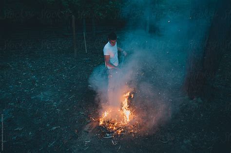 Man Building A Fire By Stocksy Contributor Michelle Edmonds Stocksy