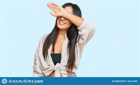 Young Beautiful Hispanic Girl Wearing Casual Clothes Covering Eyes With