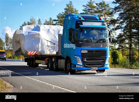 Blue Volvo Fh Semi Truck In Convoy Of Wide Load Transports Towards