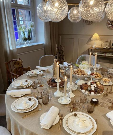 A Dining Room Table Is Set With Plates And Silverware