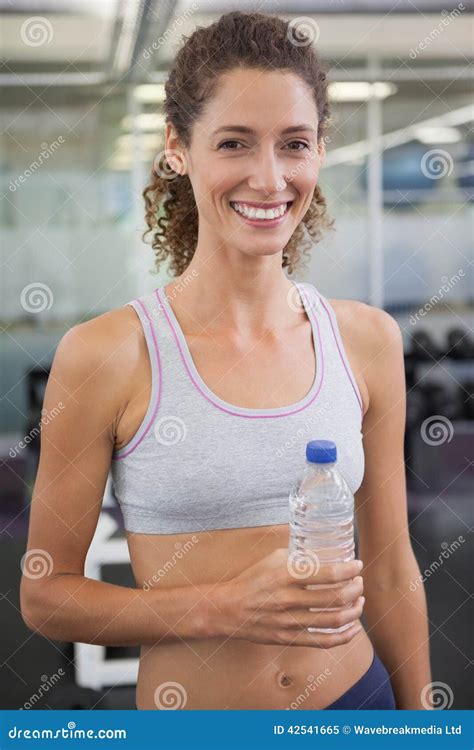 Fit Woman Smiling At Camera Holding Water Bottle Stock Image Image Of