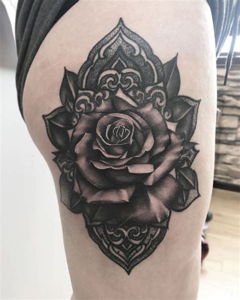 A Black And White Rose Tattoo On The Thigh