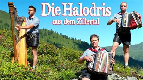 Two Men Are Playing An Accordion On The Side Of A Hill