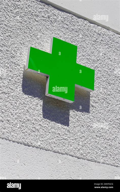 green cross logo of Pharmacy sign in street Stock Photo - Alamy