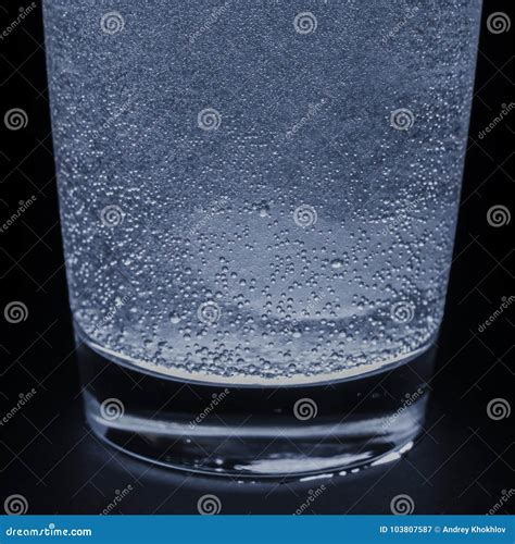 A Soluble Tablet Dropped In A Glass Of Water Over Dark Background Stock