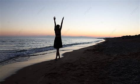 Back View Of A Woman Raising Her Hands On A Sunset Beach Photo ...