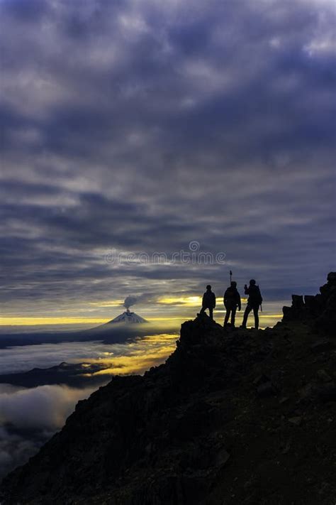 Silhouettes of Mountaineers at Sunrise in the Background the Cotopaxi ...