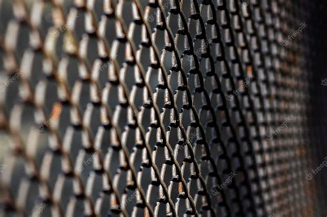 Premium Photo | Selective focus of dark metal mesh fence, pattern of ...