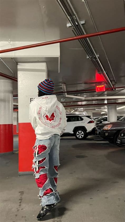 A Man Standing In A Parking Garage With His Back To The Camera And