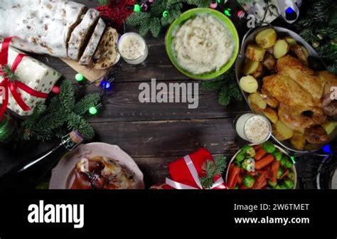 Festive Christmas Dinner Table With Traditional Foods And Dished Baked