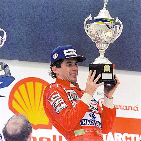 Completely Exhausted Ayrton Holds The Winners Trophybrazilian Grand