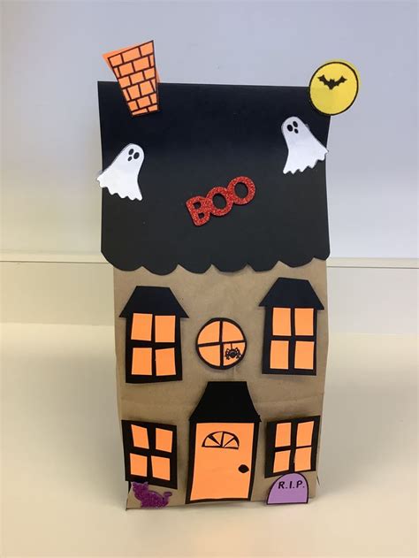 A Paper House With Halloween Decorations On It